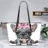 Adorable grey french bulldog puppy wearing pink roses leather tote bag