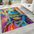 An airbrush cartoon of a blue green frog with rainbow area rugs carpet