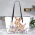 Baby rabbit sitting on top of books surrounded by flowers leather tote bag