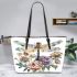 Beautiful dragonfly sitting on top of flowers leather tote bag