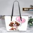 Brown and white king charles spaniel puppy with pink balloons leather tote bag