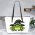 Cartoon green frog wearing black witch hat leaather tote bag