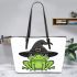 Cartoon green frog wearing black witch hat leaather tote bag