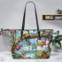 Colorful frogs hanging from tree branches in the jungle leaather tote bag