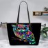 Colorful owl with glowing eyes perched leather tote bag