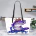 Crown on top of purple and blue tree frog cartoon caricature leaather tote bag