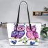 Cute and adorable two purple and pink owls sitting on the branch leather tote bag