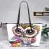 Cute baby owl with big eyes wearing leather tote bag