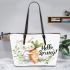 Cute bunny sitting on top of an carrot hello spring leather tote bag