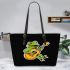 Cute cartoon frog playing guitar in a simple drawing leaather tote bag