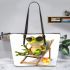 Cute cartoon frog sitting in the sun on an outdoor chair leaather tote bag