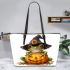 Cute cartoon frog wearing a witch hat sitting on a pumpkin leaather tote bag