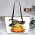 Cute cartoon frog wearing a witch hat sitting on a pumpkin leaather tote bag