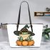 Cute cartoon frog wearing a witch's hat sitting on a pumpkin leaather tote bag