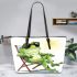 Cute cartoon frog wearing sunglasses lounging in the sun leaather tote bag