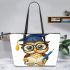 Cute cartoon owl with glasses and graduation hat holding book leather tote bag