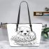 Cute cartoon puppy sitting in flower basket coloring leather tote bag