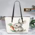 Cute cartoon rabbit holding a carrot leather tote bag