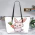 Cute cartoon rabbit holding a carrot leather tote bag