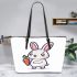 Cute cartoon rabbit holding a carrot in a simple leather tote bag