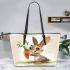 Cute cartoon rabbit holding a carrot leather tote bag