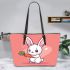 Cute cartoon rabbit playing with a carrot leather tote bag