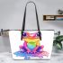 Cute cartoon rainbow frog sitting on a water puddle leaather tote bag