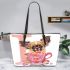 Cute chihuahua puppy inside a pink teacup with valentine candy leather tote bag