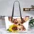 Cute chihuahua puppy with big eyes sitting next to a sunflower leather tote bag