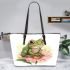 Cute frog sitting on the flower leaather tote bag