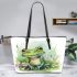 Cute frog sitting on the grass with flowers leaather tote bag