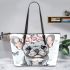 Cute grey french bulldog dog wearing a pink flower leather tote bag