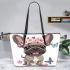 Cute grey french bulldog dog wearing a pink flower leather tote bag