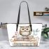 Cute owl sitting on top of books leather tote bag