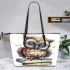 Cute owl wearing blue glasses sitting on books leather tote bag