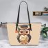 Cute owl wearing glasses and a graduation hat in a simple leather tote bag