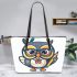 Cute owl wearing glasses and holding an octane pen leather tote bag
