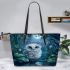 Cute owl with big blue eyes perched leather tote bag