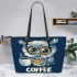 Cute owl with big yellow eyes holding a coffee cup leather tote bag