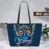 Cute owl with big yellow eyes holding a coffee cup leather tote bag