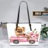 Cute pomeranian dog in a pink truck with flowers leather tote bag