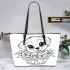 Cute puppy in flower basket with big cute eyes leather tote bag