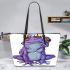 Cute purple frog wearing crown with blue skin color leaather tote bag