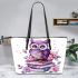 Cute purple owl sitting on top of books surrounded by pink roses leather tote bag