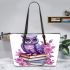 Cute purple owl sitting on top of books surrounded leather tote bag