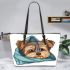 Cute yorkshire terrier dog peeking leather tote bag