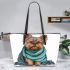 Cute yorkshire terrier wrapped in teal blanket leather tote bag