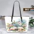 Dragonfly sitting on an open book surrounded by flowers leather tote bag
