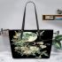 Flowers and dragonflies around the moon leather tote bag