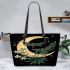 Green dragonflies flying around the moon leather tote bag